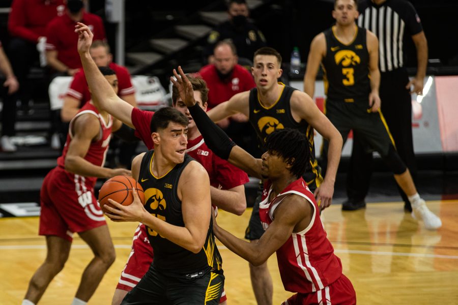 Iowa center Luka Garza looks to pass during a mens basketball game between Iowa and Wisconsin at Carver-Hawkeye Arena on Sunday, March 7, 2021. The Hawkeyes, celebrating senior day, defeated the Badgers, 77-73.
