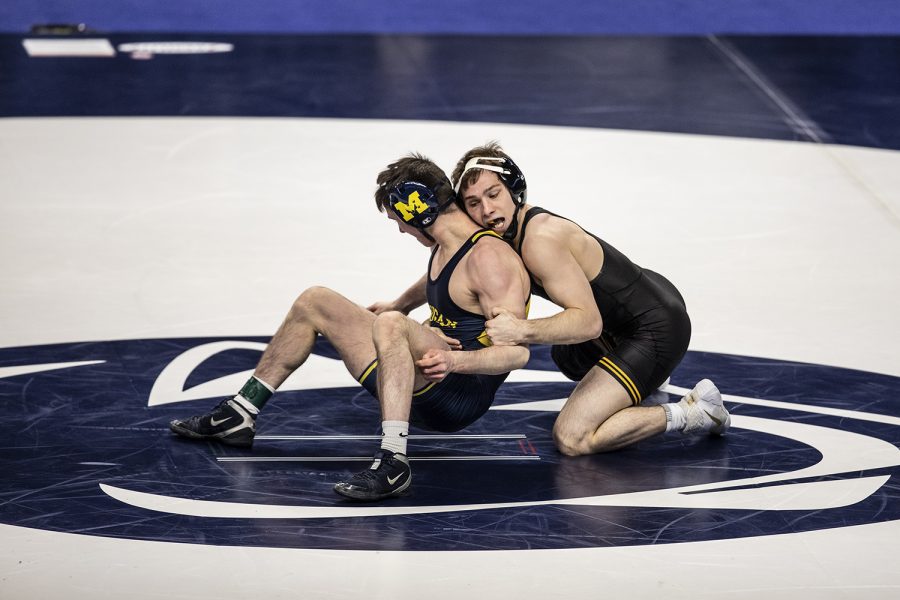 Iowa’s Spencer Lee works to maintain control on top against Dylan Ragusin of Michigan during the Big Ten Wrestling Tournament at the Bryce Jordan Center in State College, PA on Saturday, March 6, 2021. Lee won the match by tech fall with a score of 19-4. (Ryan Adams/The Daily Iowan)