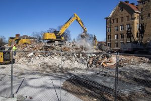 Construction equipment  began the removal of the original U of I hospital, on Tuesday, Dec.1, 2020. The hospital became Seashore hall in 1929.A worker sprays down the rubble that was once the hall, to help control dust..