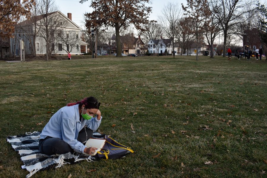 Madison Smith journals in College Green park on Wednesday, March 10, 2021. She came to College Green after getting off work for the day. 