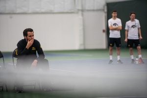 Iowa head coach Ross Wilson watches his team play during a mens tennis match between Iowa and Nebraska-Omaha at the HTRC on Saturday, Jan. 25, 2020. The Hawkeyes defeated the Mavericks, 6-1. 