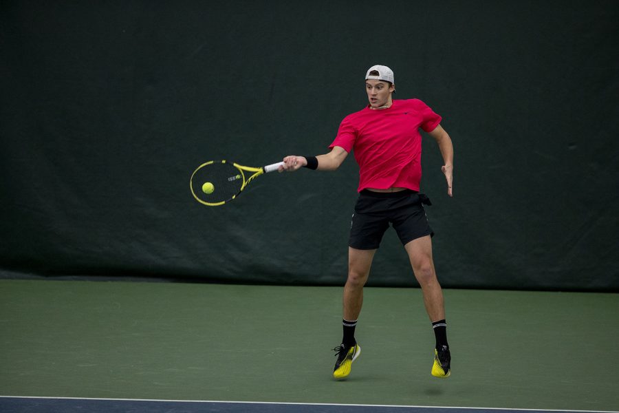 Iowa’s Joe Tyler hits the ball at the Iowa Men’s tennis meet v. Indiana in the Hawkeye Tennis and Recreation Complex on Friday, Feb. 19, 2021. Iowa defeated Indiana with a score of 5-2. 