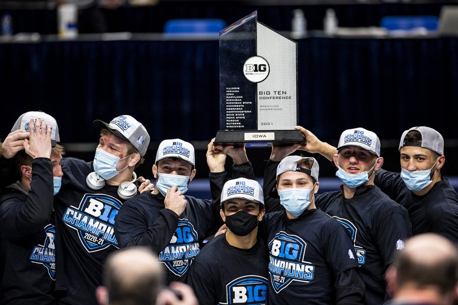 The Iowa Hawkeye wrestling team poses with the Big Ten Title trophy during the finals of the Big Ten Wrestling Tournament at the Bryce Jordan Center in State College, PA on Sunday, March 8, 2021. The Hawkeyes won the Big Ten Title with a team score of 159.5. This is the 37 Big Ten Title in school history. 