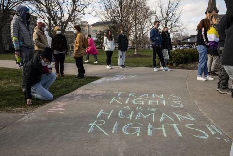 Participants chalk the sidewalk during the Trans Day of Visibility rally at the Pentacrest on Wednesday, March 31, 2021. The event was put on by the LGBTQ Iowa Archives and Library, and featured chalking and speeches by members of the community. 
