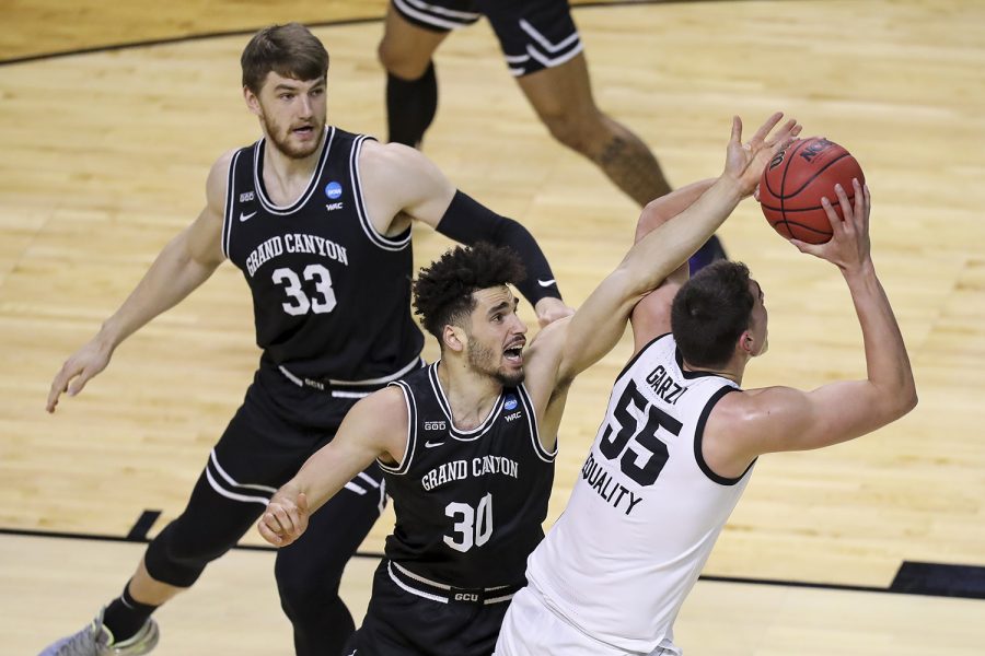 Mar 20, 2021; Indianapolis, IN, USA; Grand Canyon Antelopes center Asbjørn Midtgaard (33) and forward Gabe McGlothan (30) defend against Iowa Hawkeyes center Luka Garza (55) during the first round of the 2021 NCAA Tournament at Indiana Farmers Coliseum.  