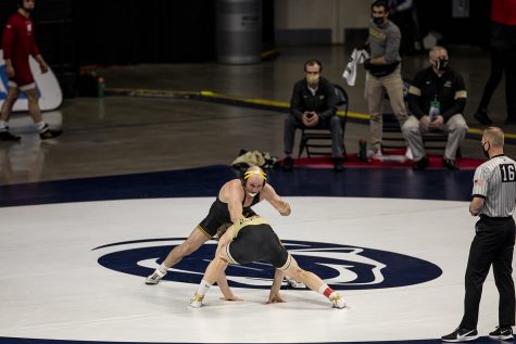 Iowa’s Alex Marinelli looks for an opening to take a shot against Purdue’s Gerrit Nijenhuis during the opening session of the Big Ten Wrestling Tournament at the Bryce Jordan Center in State College, PA on Saturday, March 6, 2021. Marinelli won the match by major decision. The Hawkeyes ended the first session with a team score of 75.5, putting them in first ahead of second place, Nebraska, with a score of 63. 