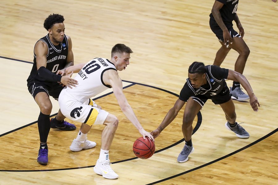 Mar 20, 2021; Indianapolis, IN, USA; Grand Canyon Antelopes guard Mikey Dixon (3) fights for the ball with Iowa Hawkeyes guard Joe Wieskamp (10) as guard Sean Miller-Moore (0) defends during the first round of the 2021 NCAA Tournament at Indiana Farmers Coliseum.  