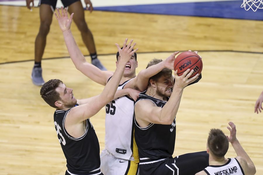 Mar 20, 2021; Indianapolis, IN, USA; Iowa Hawkeyes center Luka Garza (55) defends against Grand Canyon Antelopes center Alessandro Lever (25) and center Asbjørn Midtgaard (33) during the first round of the 2021 NCAA Tournament at Indiana Farmers Coliseum.  