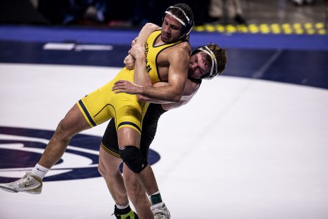 Iowa’s Jacob Warner returns Michigan’s Myles Amine to the mat during the Big Ten Wrestling Tournament at the Bryce Jordan Center in State College, PA on Saturday, March 6, 2021. Amine won the match by decision 3-1. The Hawkeyes ended the Semifinals  with a team score of 126.5, putting them in first place ahead of Penn State with a score of 111.5. 