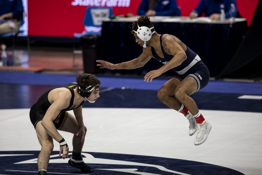 Penn States Roman Bravo-Young leaps to avoid shots taken by Iowa’s Austin DeSanto during the finals of the Big Ten Wrestling Tournament at the Bryce Jordan Center in State College, PA on Sunday, March 8, 2021. Bravo-Young won the match by decision 5-2. The Hawkeyes won the Big Ten Title with a team score of 159.5. This is the 37 Big Ten Title in school history. 