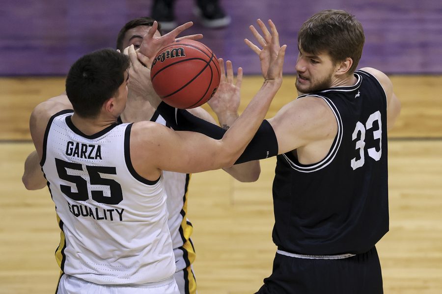 Mar 20, 2021; Indianapolis, IN, USA; Iowa Hawkeyes center Luka Garza (55) and Grand Canyon Antelopes center Asbjørn Midtgaard (33) fight for the ball during the first round of the 2021 NCAA Tournament at Indiana Farmers Coliseum.  