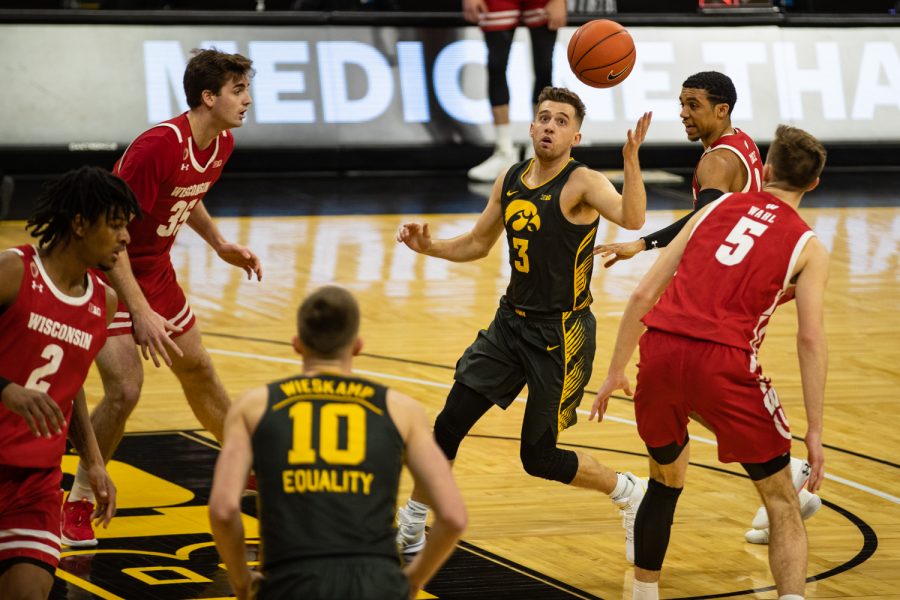Iowa guard Jordan Bohannon controls the ball during a mens basketball game between Iowa and Wisconsin at Carver-Hawkeye Arena on Sunday, March 7, 2021. The Hawkeyes, celebrating senior day, defeated the Badgers, 77-73.