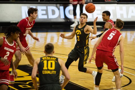 Iowa guard Jordan Bohannon controls the ball during a mens basketball game between Iowa and Wisconsin at Carver-Hawkeye Arena on Sunday, March 7, 2021. The Hawkeyes, celebrating senior day, defeated the Badgers, 77-73. (Shivansh Ahuja/The Daily Iowan)
