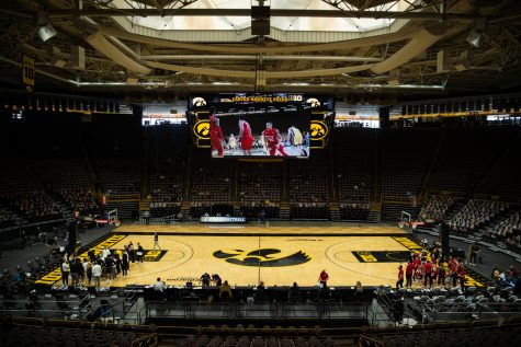 Teams huddle during a timeout during a mens basketball game between Iowa and Wisconsin at Carver-Hawkeye Arena on Sunday, March 7, 2021. The Hawkeyes, celebrating senior day, defeated the Badgers, 77-73.