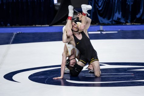Iowa’s Spencer Lee attempts a takedown against Purdue’s Devin Schroder during the finals of the Big Ten Wrestling Tournament at the Bryce Jordan Center in State College, PA on Sunday, March 8, 2021. Lee won the match with a tech fall 21-3.