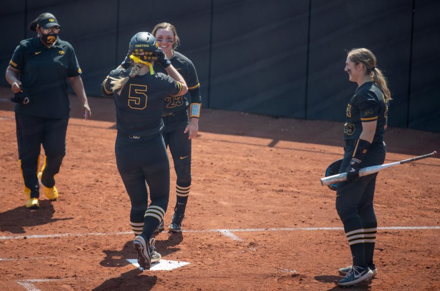 Iowa first basemen Denali Loecker touches home plate during a softball game at Pearl Field on Saturday, April 3 during a softball game between Iowa and Indiana. Loecker collected two RBIs.The Hawkeyes defeated the Hoosiers 8-0 in five innings.