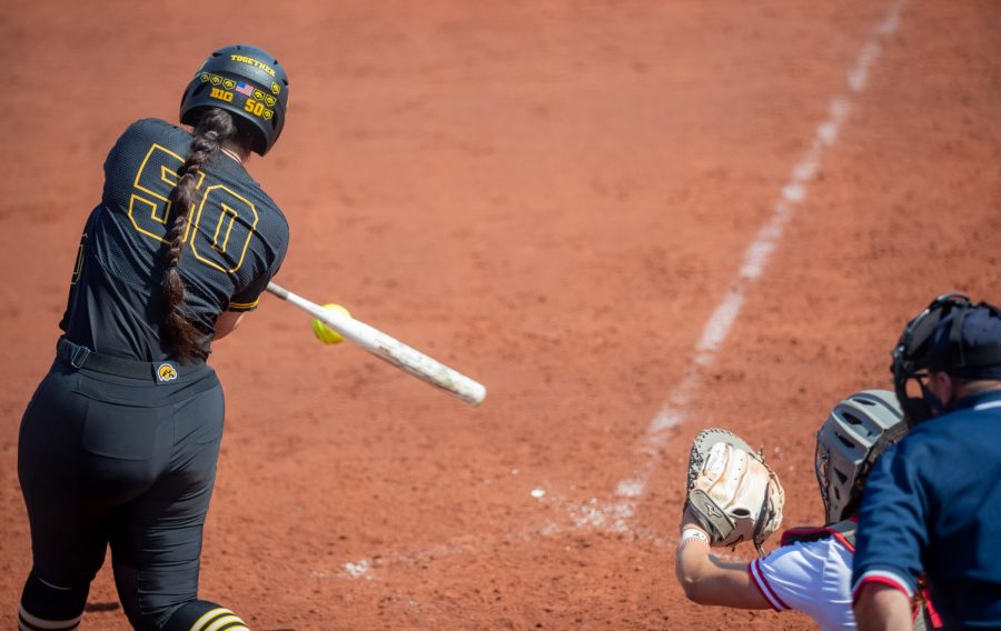 Iowa pinch hitter Kalena Burns connects with the ball for a bases clearing triple during a softball game at Pearl Field on Saturday, April 3 during a softball game between Iowa and Indiana. Burns finished the game with five RBIs.The Hawkeyes defeated the Hoosiers 8-0 in five innings.