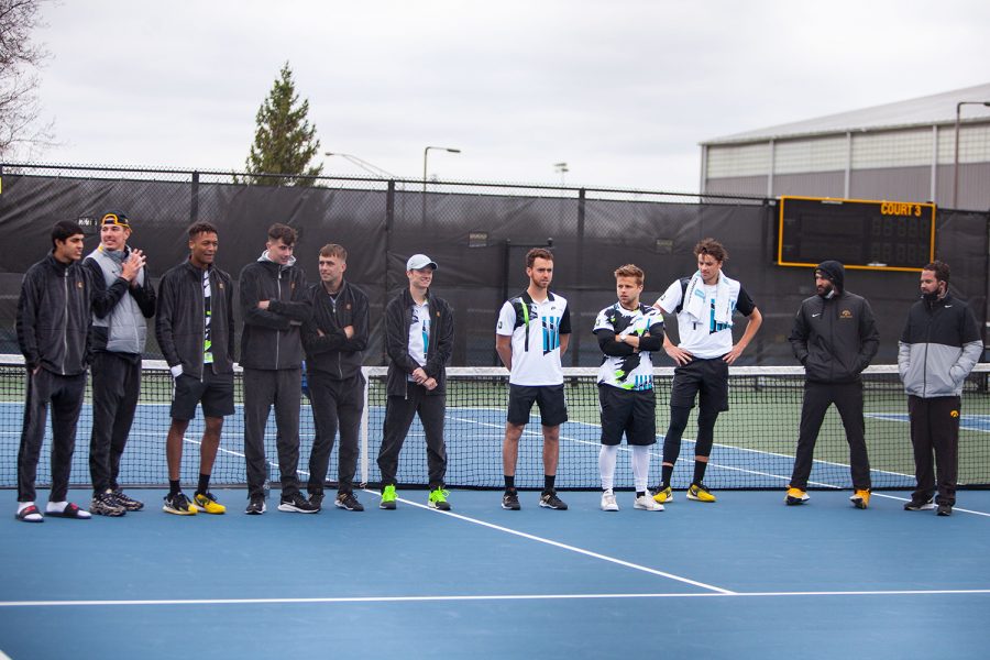 Iowa men’s tennis team stands as the seniors are recognized after a men’s tennis meet between Iowa and Northwestern on Sunday, April 11 at the Hawkeye Tennis and Recreation Complex. The Wildcats defeated the Hawkeyes 6-1. Iowa Athletics has cut men’s tennis making this their last home meet in their final season. 