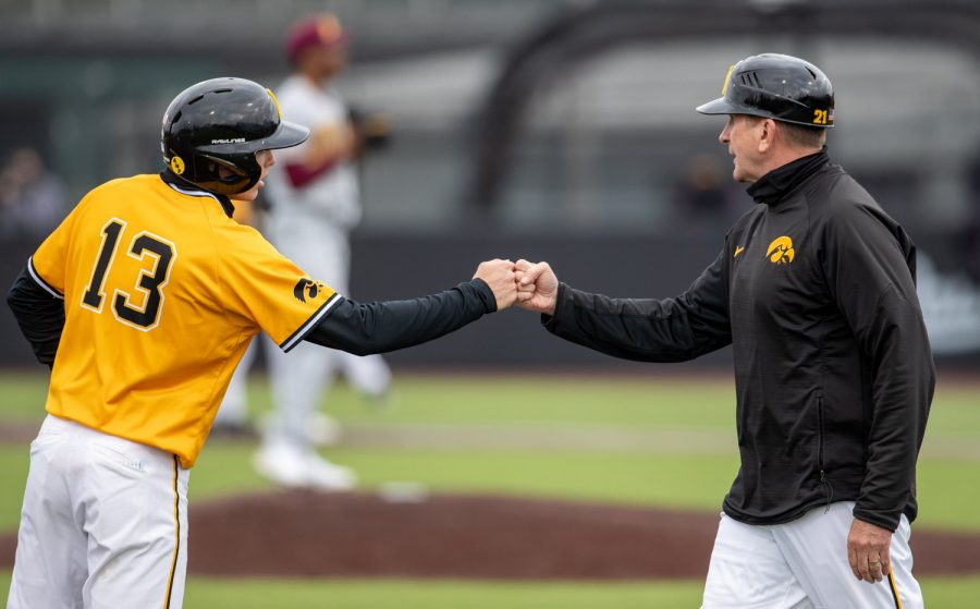 Iowa+second+basemen+Michael+Sergers+fist+bumps+head+coach+Rick+Heller+during+a+baseball+game+between+Iowa+and+Minnesota+at+Duane+Banks+Field+on+Sunday%2C+April+11%2C+2021.+The+Hawkeyes+defeated+the+Gophers+18-0.
