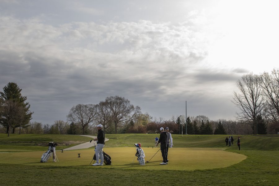 Iowa’s Alex Schaake (left) gets ready to tee off during the third round of the Hawkeye Invitational at Finkbine Golf Course on Sunday, April 18, 2021. Iowa won the invitational with a final overall score of 840.