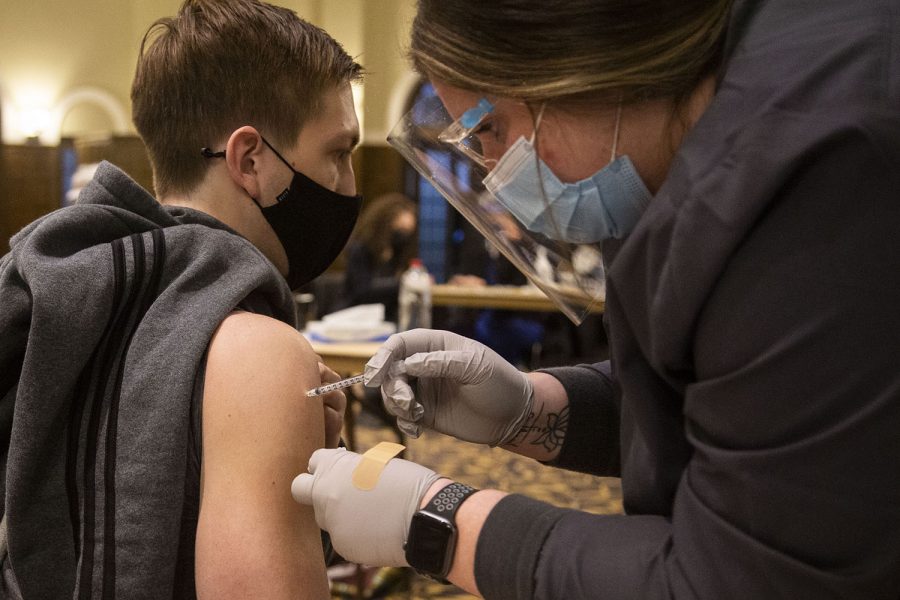 Junior Adam Kroll receives the Pfizer COVID-19 vaccine at the Iowa Memorial Union at the University of Iowa on Wednesday, April 21, 2021.
