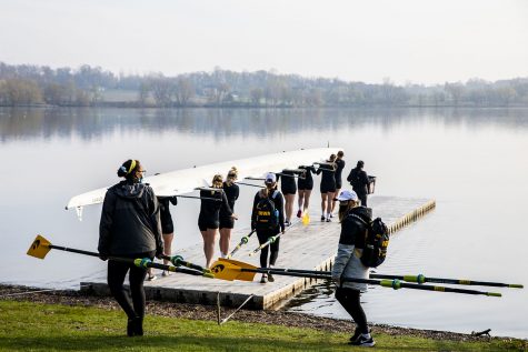 The 2 Novice 8 carry their boat to the water on Saturday, April 24, 2021.