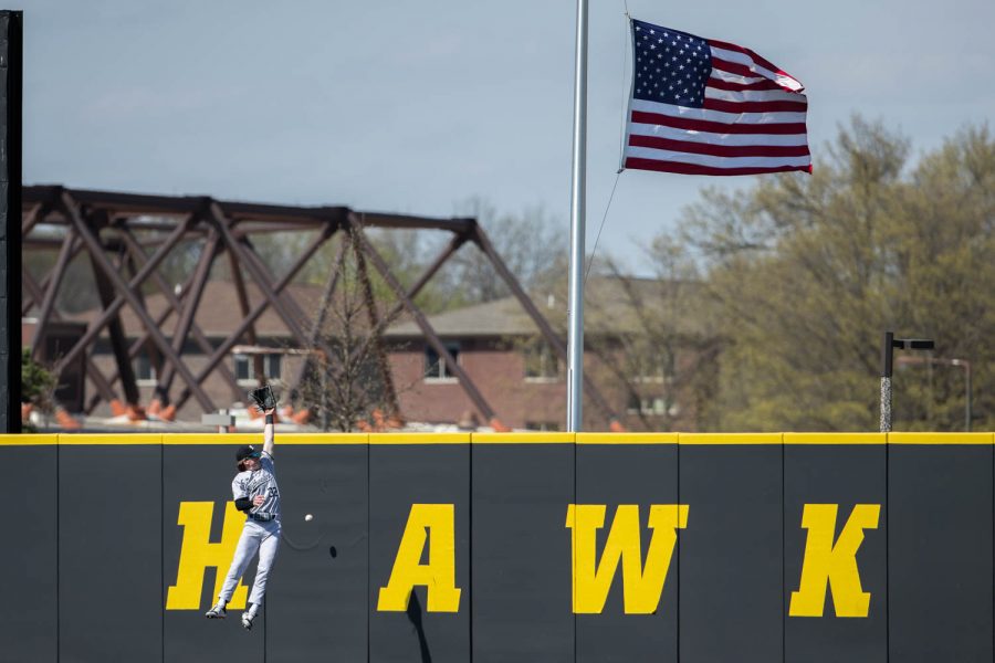 Northwesterns Ethan ODonnell tries to catch a ball during a baseball game in Iowa City between Iowa and Northwestern. The Hawks beat the Wildcats 9-8. 