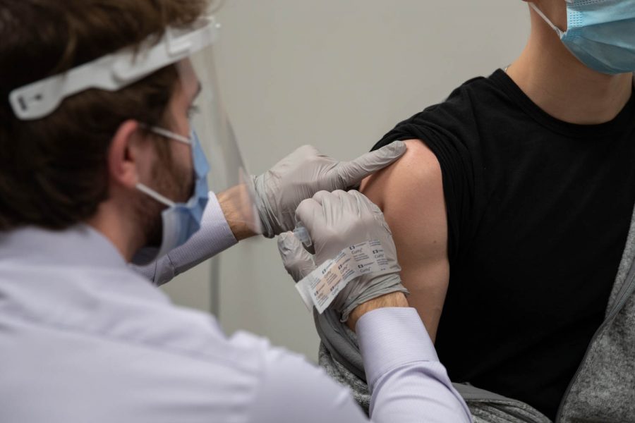 A student recieves a COVID vaccine on Friday, Jan. 29, 2021 at the UI Medical Education Research Facility.