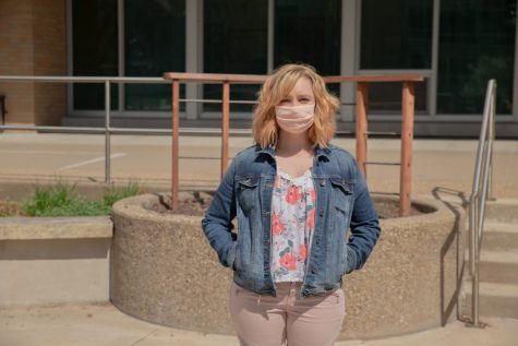 Americorps Member and Cashier Megan Hill stands in front of Iowa City Hall on April 14 2021.