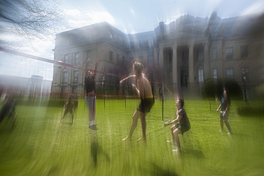The University of Iowa Club Volleyball team practices on the Pentacrest in downtown Iowa City on Thursday, April 21, 2021. Now that the weather has finally warmed up and that the team has been fully vaccinated, the team decided to head out and hold an informal practice.