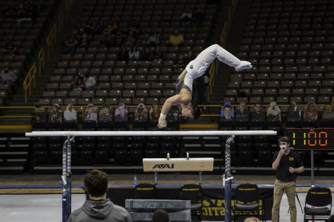 Iowa all-around Bennet Huang competes on the parallel bars during the Iowa v. Nebraska men’s gymnastics meet in Carver-Hawkeye Arena on Saturday, March 20, 2021. Iowa defeated Nebraska with a score of 406.700 - 406.650. Huang placed third on the parallel bars with a score of 13.750.