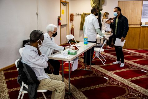 People wait for their vaccinations in the prayer room on Saturday, April 12, 2021. A clinic was being held by Hartig Pharmacy at the Al-Iman Mosque in Iowa City.