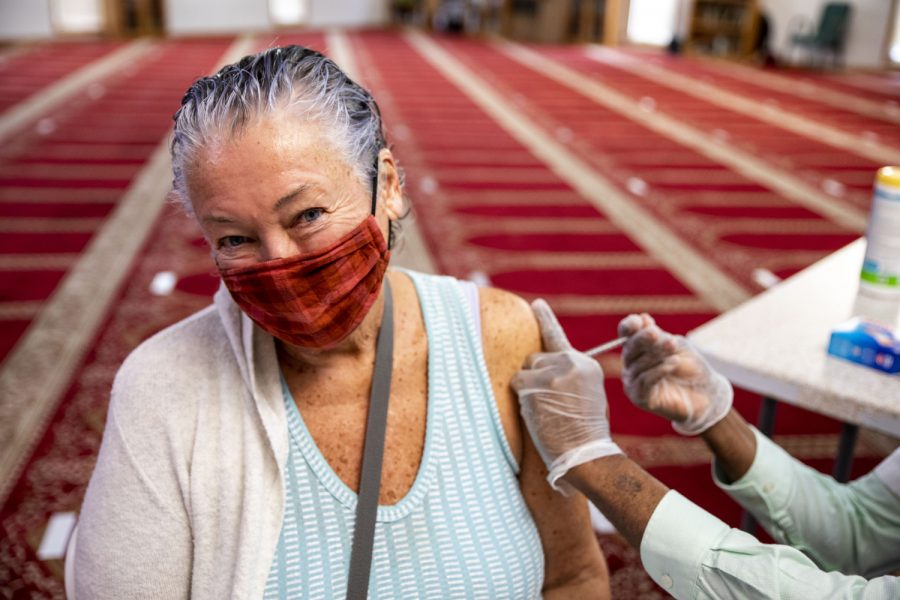 A customer receives her first dose of the vaccine on Saturday, April 12, 2021. Hartig Pharmacies were administering the Pfizer vaccine at a clinic held at the Al-Eman Mosque. 