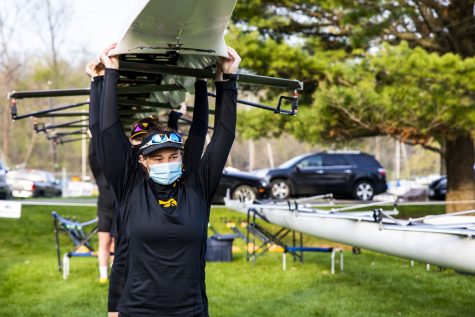 Iowa rowing moves their boat to the dock on Saturday, April 24, 2021 during The Iowa Rowing Regatta at Lake MacBride. Iowa competed against Minnesota, Wisconsin, Drake, and Kansas during the one-day event.