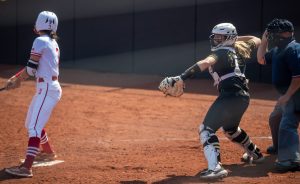 Iowa catcher Lindy Milkowski attempts to pick off a runner on third after a strike during a softball game at Pearl Field on Saturday, April 3 during a softball game between Iowa and Indiana. The Hawkeyes defeated the Hoosiers 8-0 in five innings.