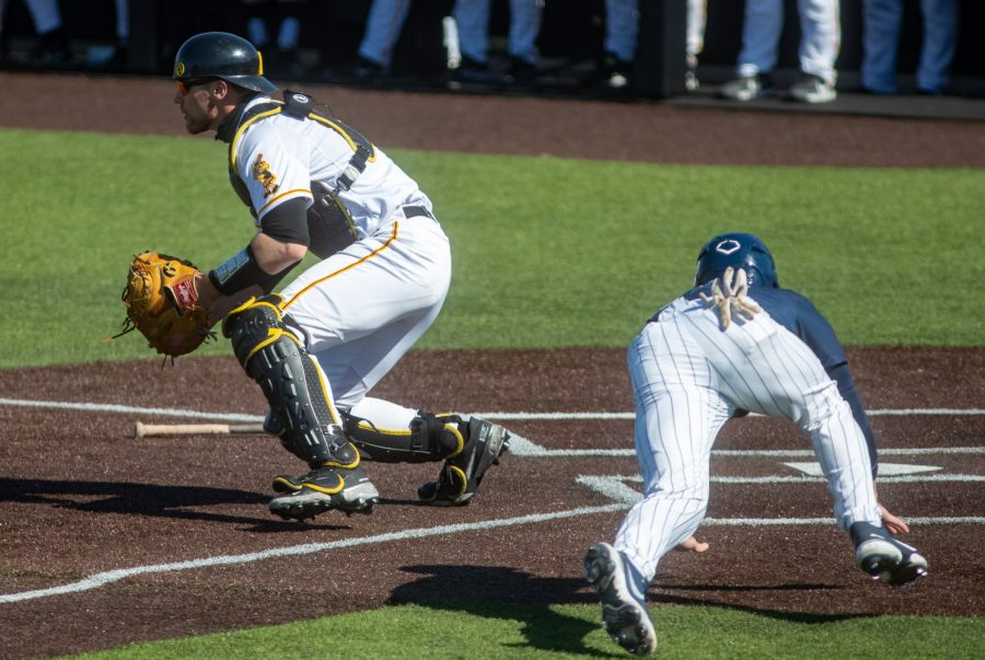 Iowa catcher Austin Martin waits for the ball to come in while Penn State scores a run during a baseball game between Iowa and Penn State on Friday, May 7, 2021 at Duane Banks Field. The Hawkeyes defeated the Nittany Lions 4-2.