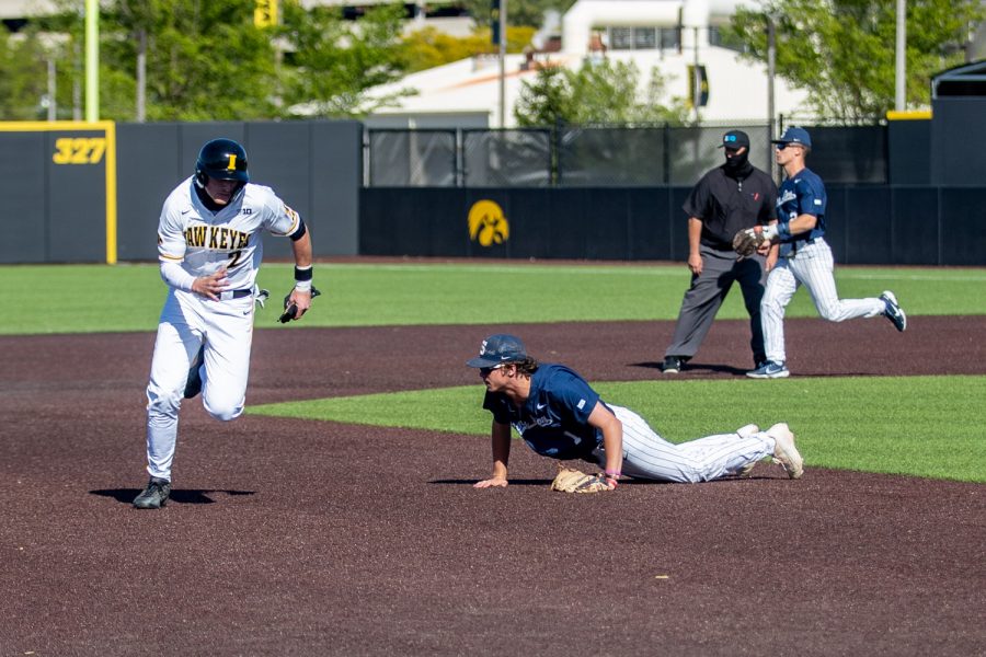 Iowa shortstop Brendan Sher runs to third after a ball gets past Penn State third basemen Justin Williams during a baseball game between Iowa and Penn State on Friday, May 7, 2021 at Duane Banks Field. The Hawkeyes defeated the Nittany Lions 4-2.