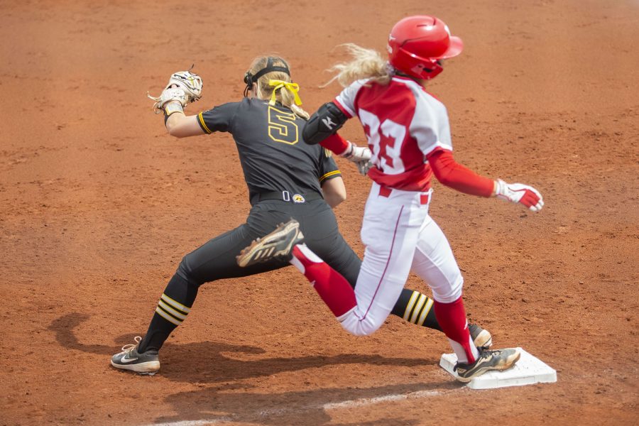Nebraska catcher Anni Raley runs to first base as Iowa utility player Denali Loecker gets her out during the Iowa softball game v. Nebraska at Pearl Field on Saturday, May 8, 2021. The Huskers defeated the Hawkeyes with a score of 4-0.