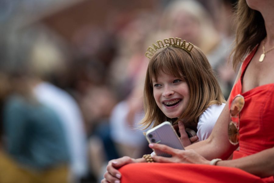 A child smiles with a headband saying “Grad-Squad” during the University of Iowa’s celebration of graduates Sunday, May 16, 2021, at Kinnick Stadium. (Kate Heston/The Daily Iowan)