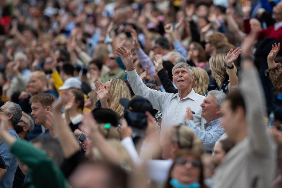 Graduates and their families and friends take part in the “Iowa Wave,” a tradition in which fans wave to children at the children’s hospital, during the University of Iowa’s celebration of graduates Sunday, May 16, 2021, at Kinnick Stadium. (Kate Heston/The Daily Iowan)