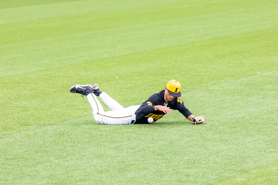 Iowa infielder/right-hand pitcher Dylan Nedved dives for the ball during the Iowa Baseball game against Illinois on May 15, 2021 at Duane Banks Field. Illinois defeated Iowa 14-1. 