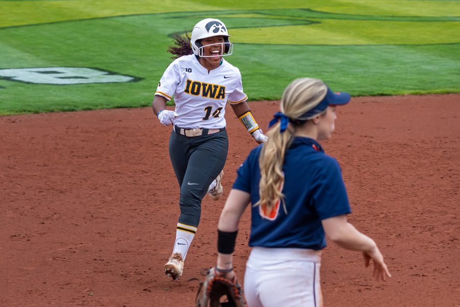 Iowa outfielder Nia Carter runs to third base and cheers as teammate Grace Banes hits a 2-run home run during the Iowa Softball senior game against Illinois on May 16, 2021 at Bob Pearl Field. Iowa defeated Illinois 4-3. 