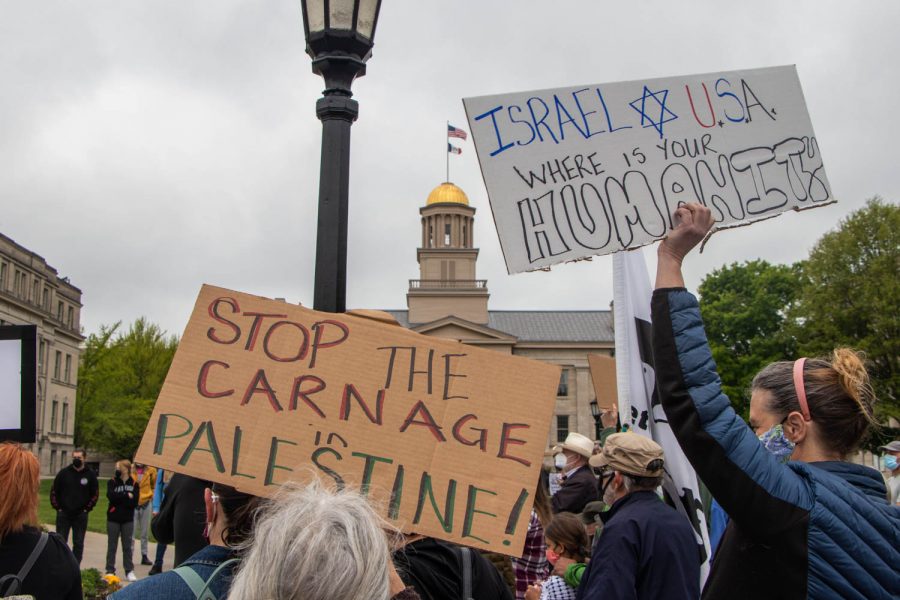 Signs demanding change are held high at a protest for Palestine on May 15, 2021 on the Pentacrest in Iowa City, Iowa. 