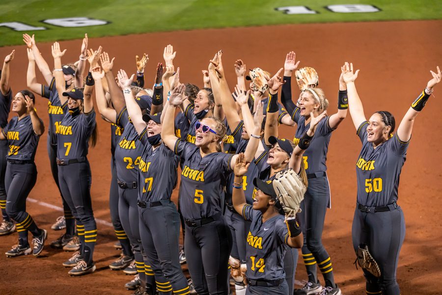 The Iowa Hawkeyes celebrate their win with fans by chanting IOWA and spelling out the letters above their heads after the Iowa Softball game against Illinois on May 14, 2021 at Bob Pearl Field. Iowa defeated Illinois 3-1.