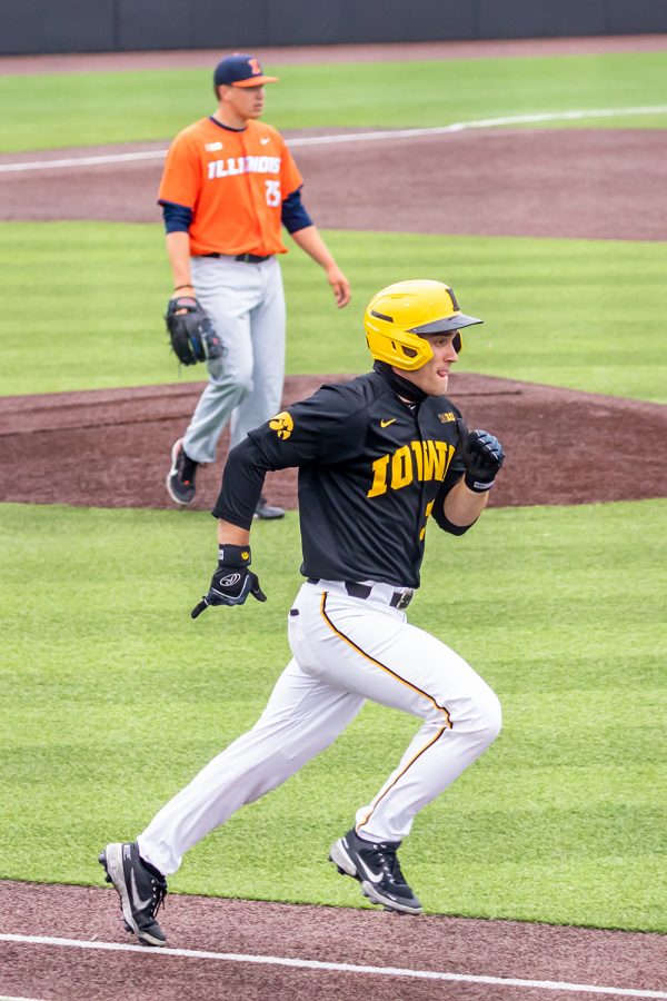 Iowa catcher Austin Martin runs to first base after hitting the ball during the Iowa Baseball game against Illinois on May 15, 2021 at Duane Banks Field. Illinois defeated Iowa 14-1. 