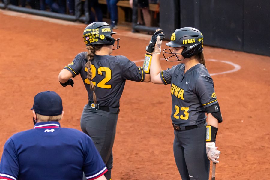 Iowa utility players Brylee Klosterman and Grace Banes celebrate the Hawkeye’s first run during the Iowa Softball game against Illinois on May 14, 2021 at Bob Pearl Field. Iowa defeated Illinois 3-1. 