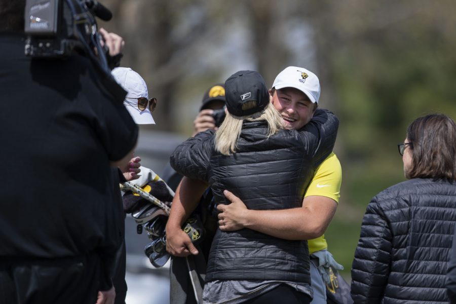 Iowa’s Alex Schaake embraces family members after winning the Hawkeye Invitational at Finkbine Golf Course on Sunday, April 18, 2021. Iowa won the invitational 24 under par.