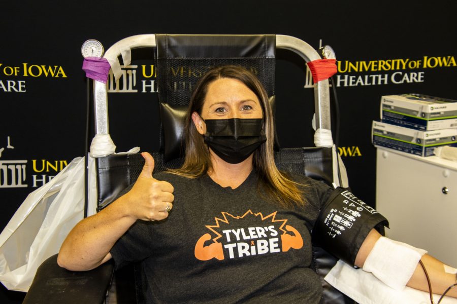 Kari Juhl gives a thumbs up while donating blood during a blood drive that is being held for her son Tyler who is battling cancer. Friday, June, 25, 2021. (Jeff Sigmund/Daily Iowan)