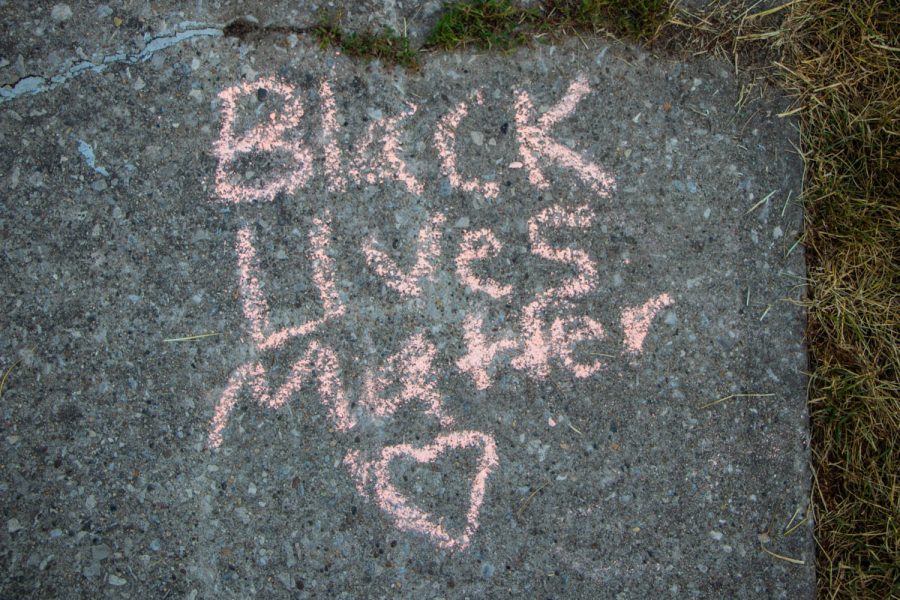 The words “Black Lives Matter” is seen written in chalk at a Juneteenth celebration hosted by Iowa Freedom Riders on June 19, 2021.