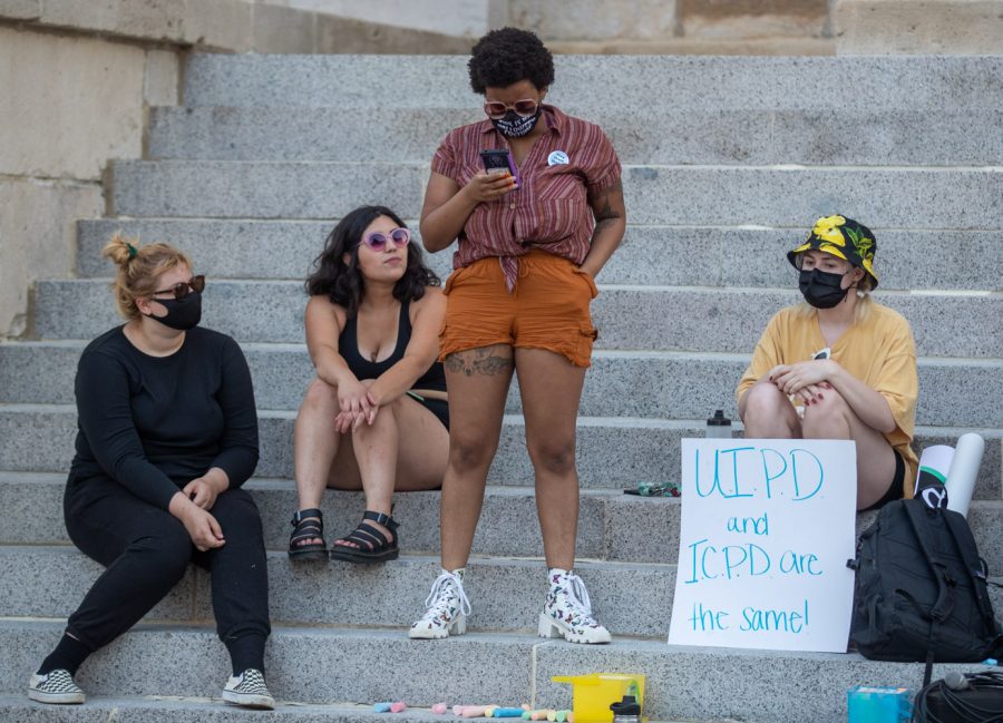 Members of the Cops off Campus organization speak to the crowd during a protest on the Pentacrest in Iowa City on Sunday, July 4, 2021.  